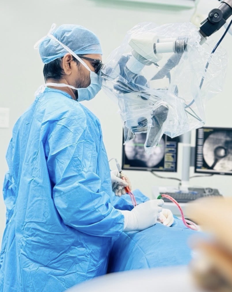 Dr. Hari Kishore performing keyhole spine surgery using high-precision surgical microscope